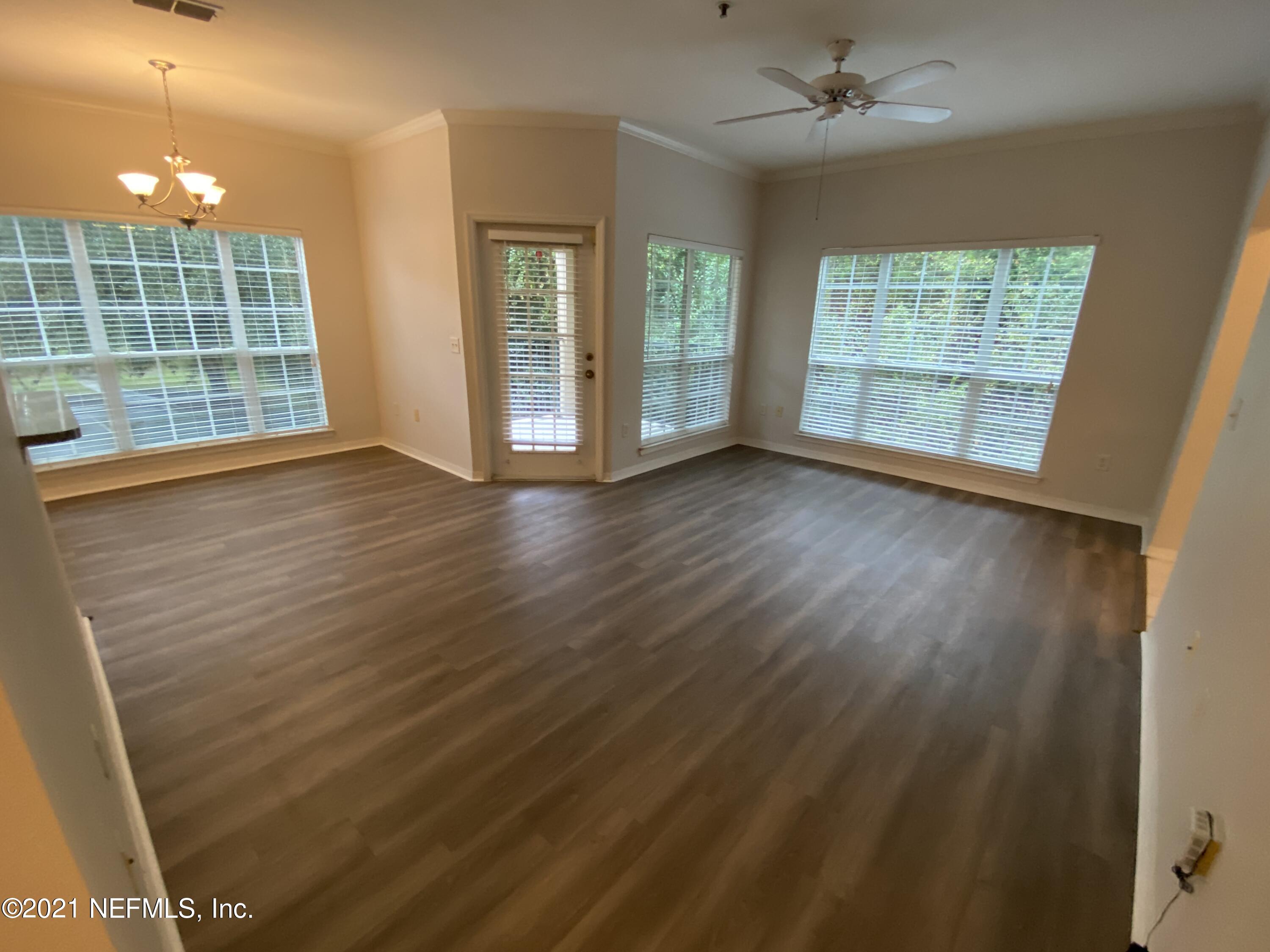 7800 Point Meadows Drive, Unit 422 Jacksonville, FL 32256 - Photo 23 of 38 an empty room with wooden floor and windows
