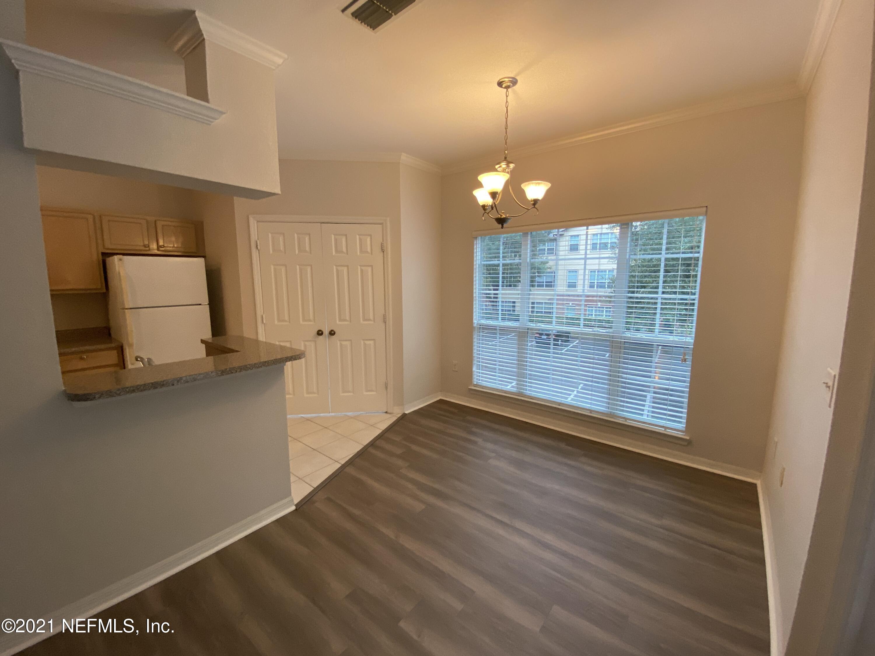 7800 Point Meadows Drive, Unit 422 Jacksonville, FL 32256 - Photo 24 of 38 a view of a livingroom with a furniture wooden floor and window