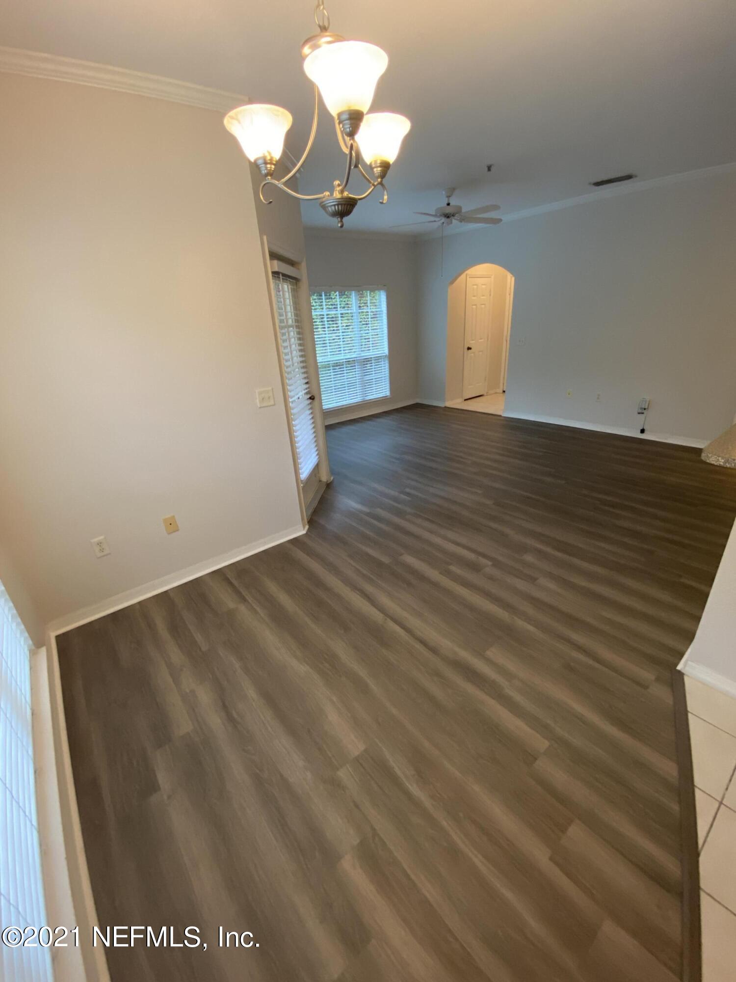 7800 Point Meadows Drive, Unit 422 Jacksonville, FL 32256 - Photo 25 of 38 wooden floor in an empty room with a window
