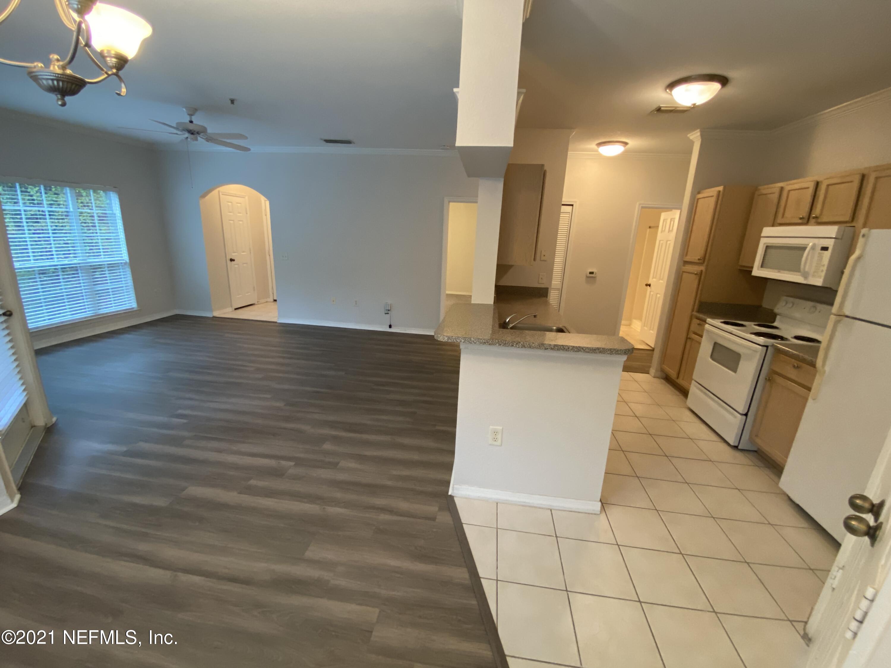 7800 Point Meadows Drive, Unit 422 Jacksonville, FL 32256 - Photo 26 of 38 a view of a kitchen with furniture and a window