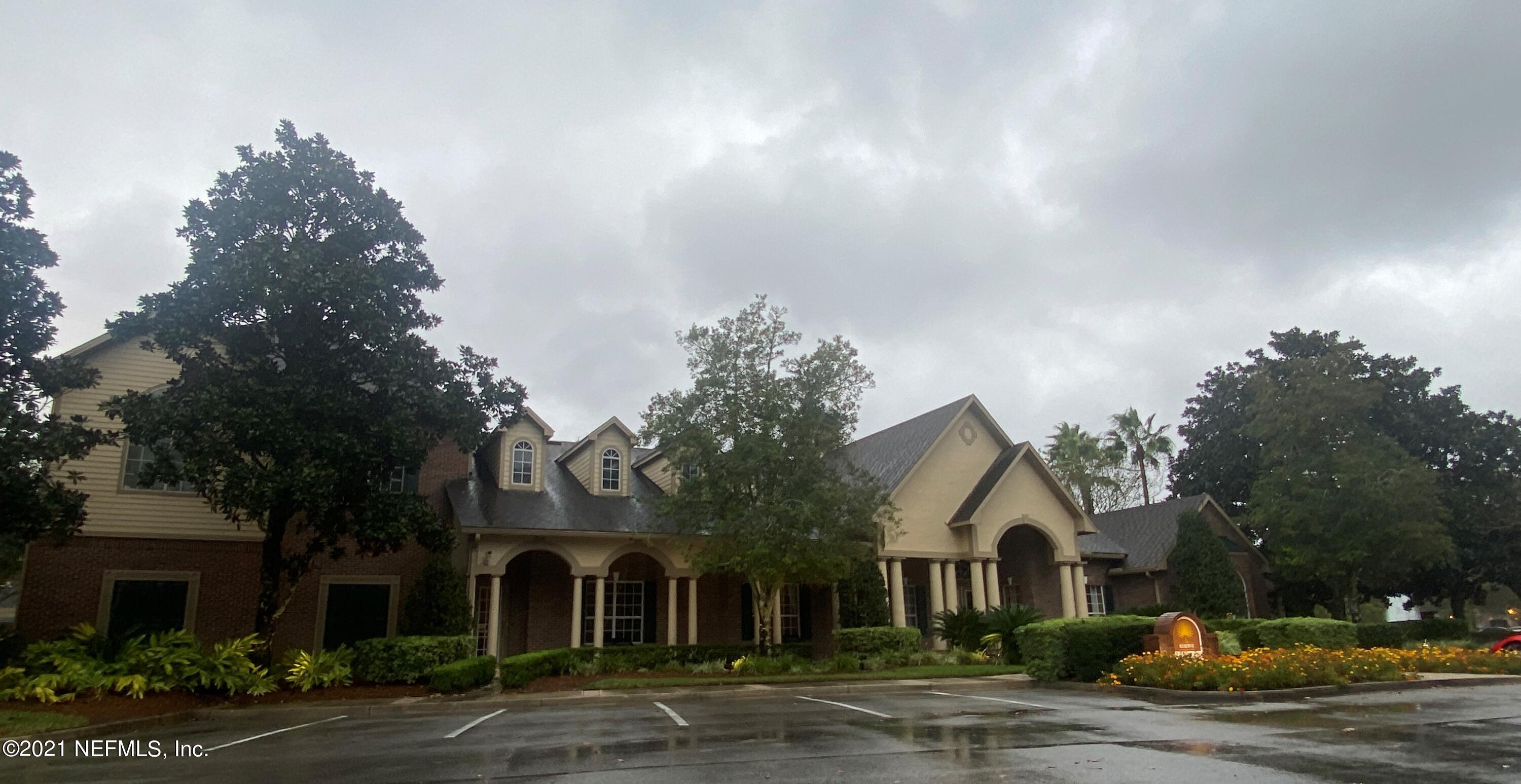 7800 Point Meadows Drive, Unit 422 Jacksonville, FL 32256 - Photo 37 of 38 a front view of a house with a yard and garage