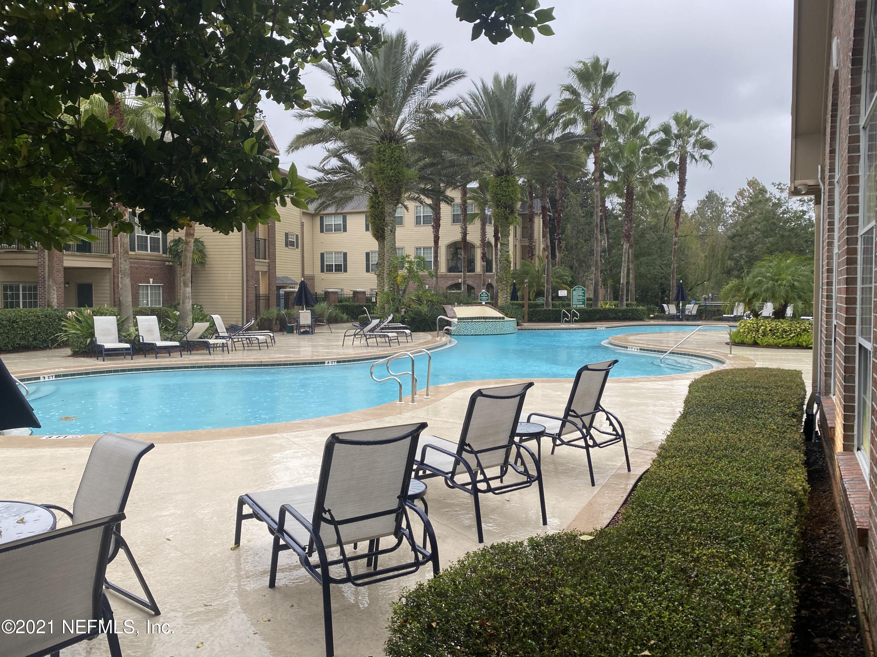 7800 Point Meadows Drive, Unit 422 Jacksonville, FL 32256 - Photo 38 of 38 a view of a swimming pool with a lounge chairs