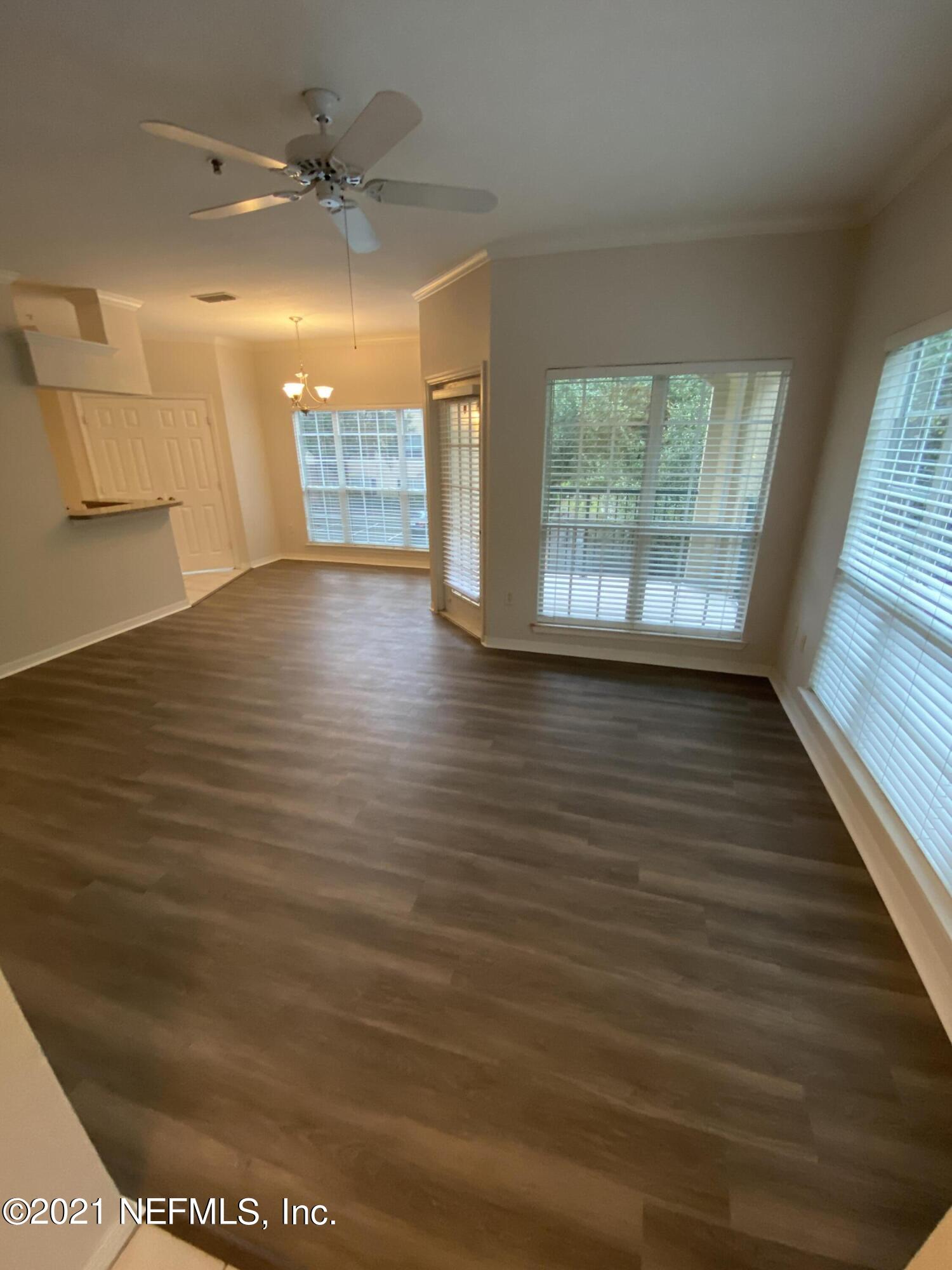 7800 Point Meadows Drive, Unit 422 Jacksonville, FL 32256 - Photo 5 of 38 a view of empty room with wooden floor and fan