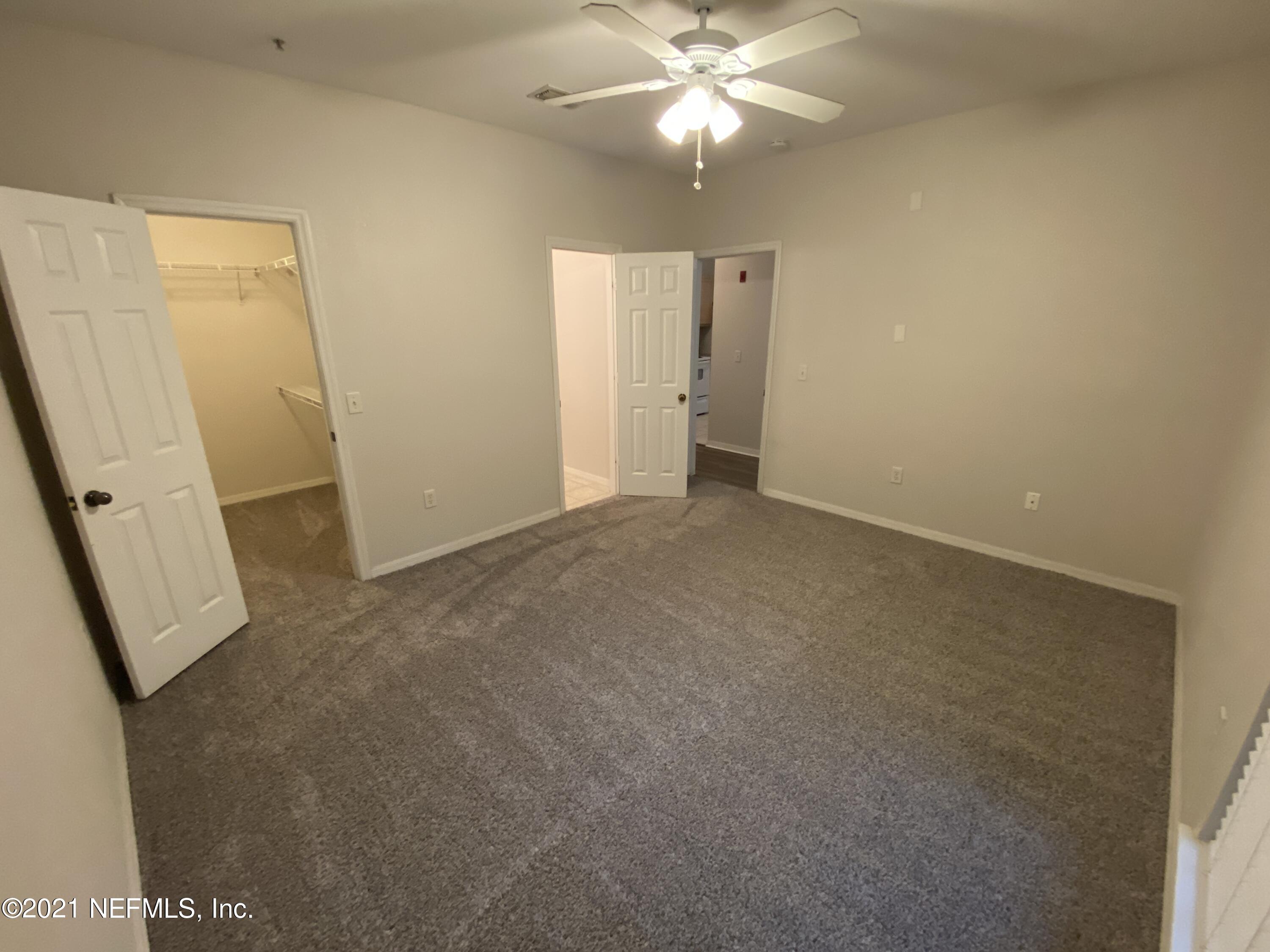 7800 Point Meadows Drive, Unit 422 Jacksonville, FL 32256 - Photo 10 of 38 an empty room with windows and fan