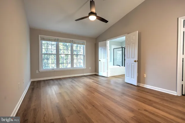 an empty room with wooden floor and cabinet