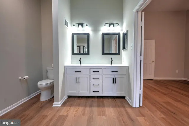 a view of a room with wooden floor