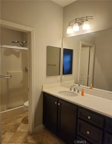 a bathroom with a tub sink and mirror