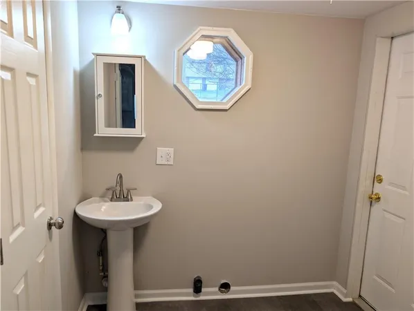 a white toilet sitting next to a white wall