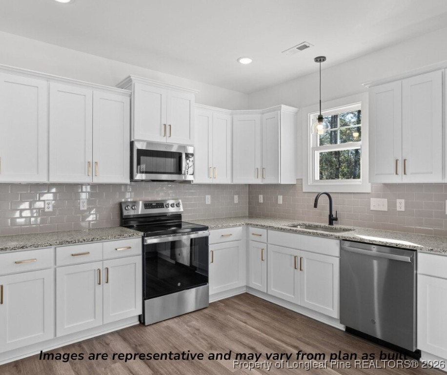 9790 Rockfish Road Raeford, NC 28376 - Photo 4 of 8 a kitchen with a sink stove and microwave