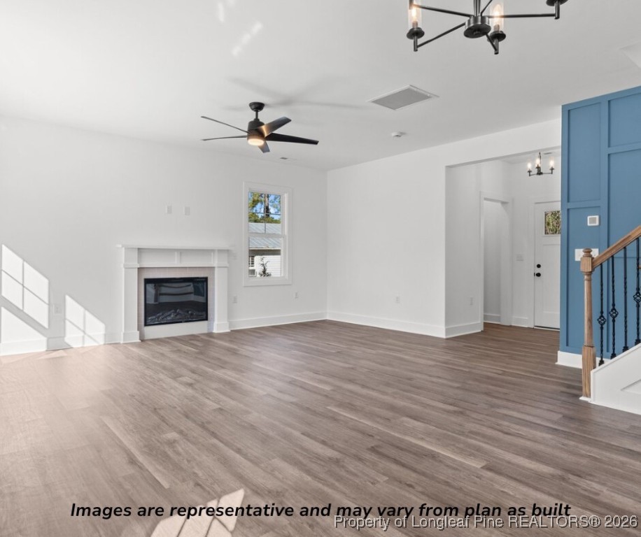 9790 Rockfish Road Raeford, NC 28376 - Photo 5 of 8 wooden floor in an empty room with a fireplace