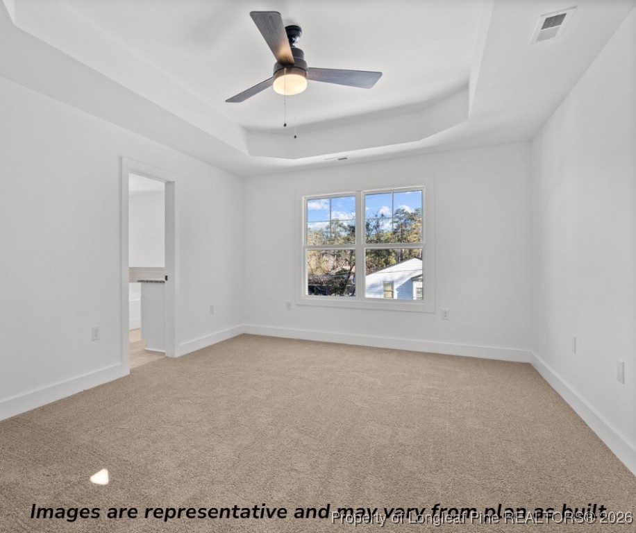 9790 Rockfish Road Raeford, NC 28376 - Photo 6 of 8 an empty room with windows and ceiling fan