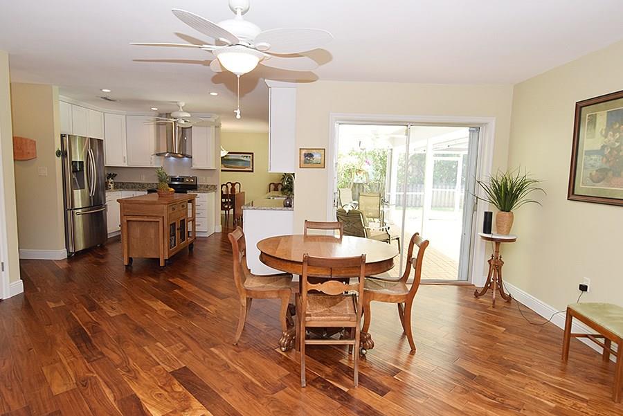 1975 Northwest Fork Road Stuart, FL 34994 - Photo 20 of 35 a dining room with furniture a window and wooden floor