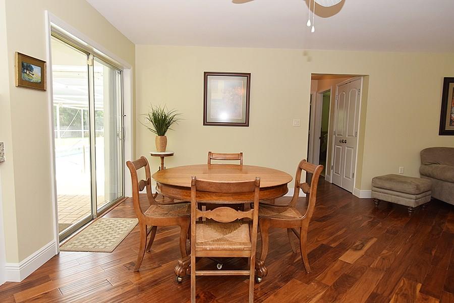 1975 Northwest Fork Road Stuart, FL 34994 - Photo 21 of 35 a dining room with furniture window and wooden floor