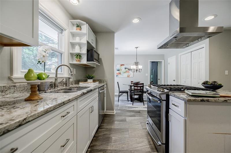 2343 Hunting Valley Drive Decatur, GA 30033 - Photo 14 of 71 a kitchen with stainless steel appliances granite countertop a sink stove and cabinets