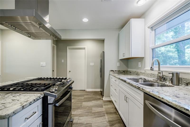 2343 Hunting Valley Drive Decatur, GA 30033 - Photo 17 of 71 a kitchen with granite countertop stainless steel appliances a sink stove and window