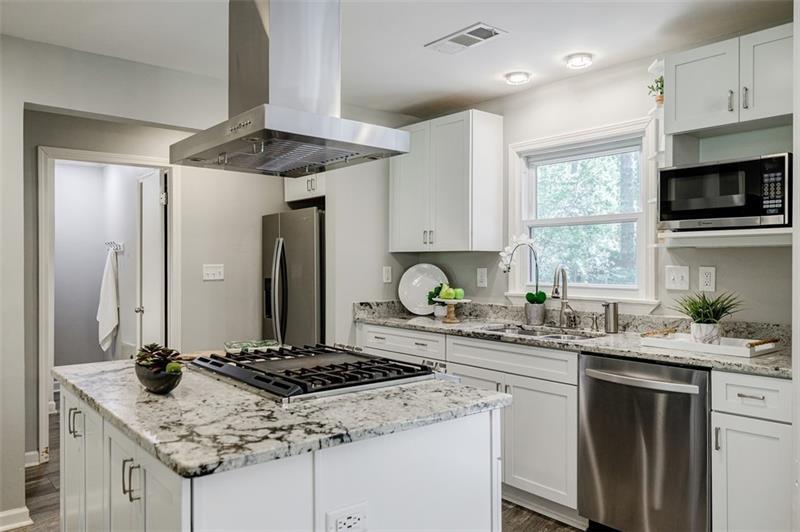 2343 Hunting Valley Drive Decatur, GA 30033 - Photo 19 of 71 a kitchen with stainless steel appliances granite countertop a sink stove cabinets and refrigerator