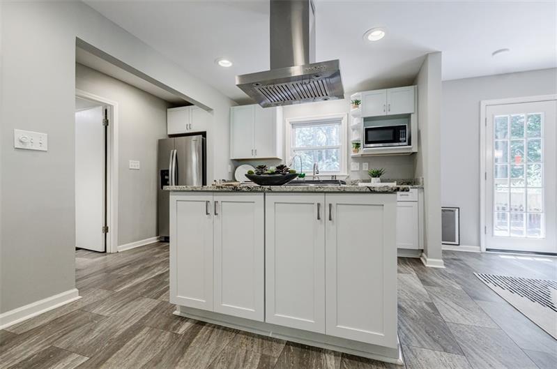 2343 Hunting Valley Drive Decatur, GA 30033 - Photo 20 of 71 a kitchen with kitchen island granite countertop a sink cabinets and stainless steel appliances