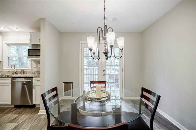 2343 Hunting Valley Drive Decatur, GA 30033 - Photo 26 of 71 a view of a dining room with furniture a chandelier and wooden floor