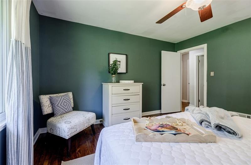 2343 Hunting Valley Drive Decatur, GA 30033 - Photo 30 of 71 a bedroom with a bed and a chair with the wall