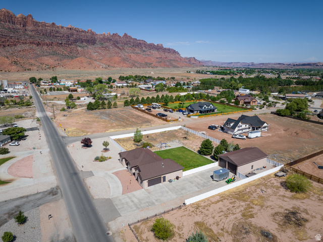 4635 East Sunny Acres Lane Moab, UT 84532 - Photo 8 of 56 Expansive property featuring a paved driveway, detached garage structure, and a large grassy area