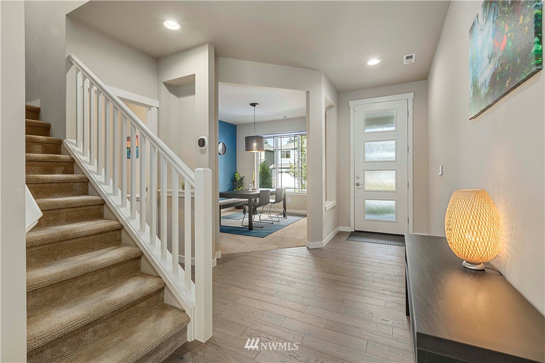 17512 Meridian Place West Bothell, WA 98012 - Photo 11 of 28 a view of a hallway with wooden floor and staircase