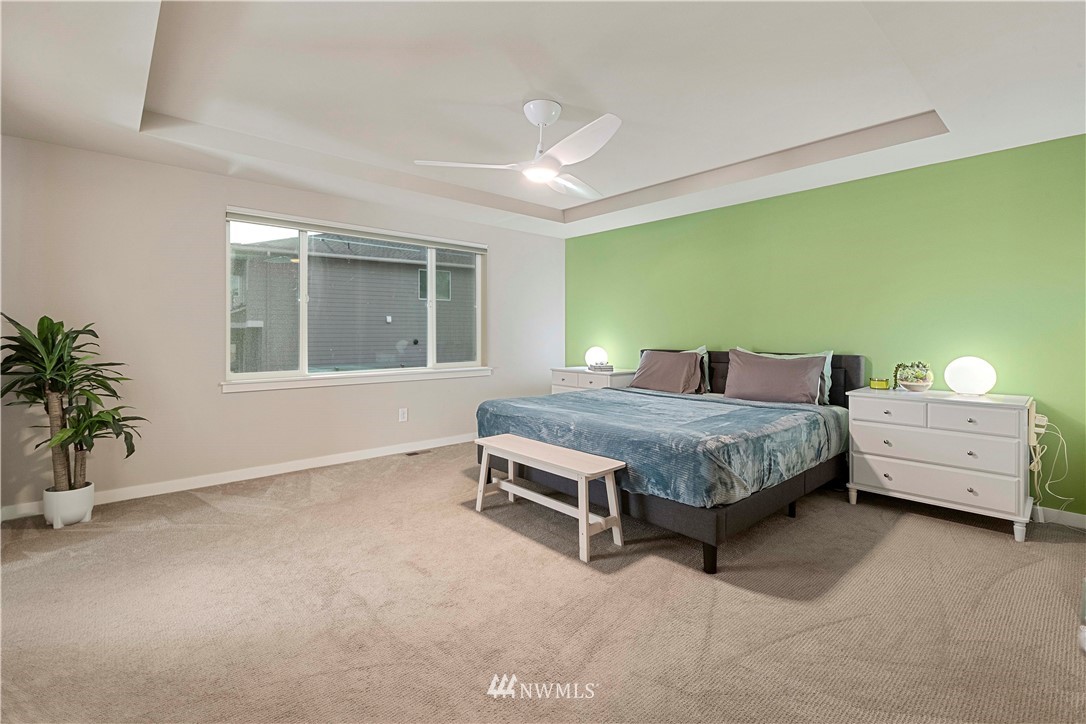 17512 Meridian Place West Bothell, WA 98012 - Photo 15 of 28 a bedroom with a bed and a potted plant