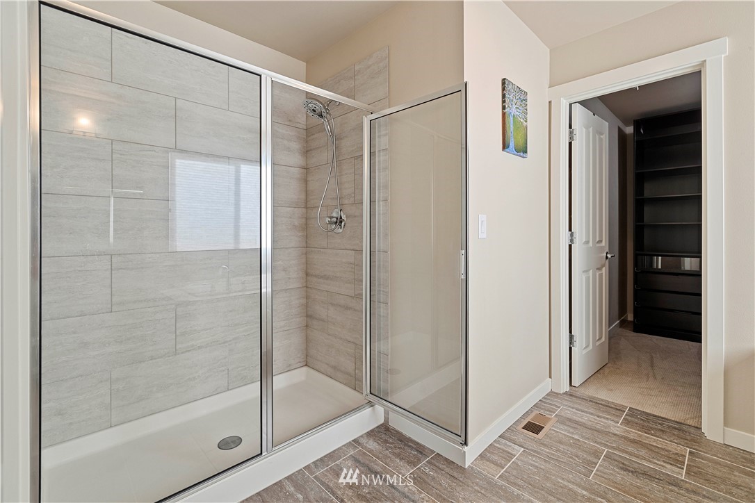 17512 Meridian Place West Bothell, WA 98012 - Photo 17 of 28 a bathroom with a glass shower door