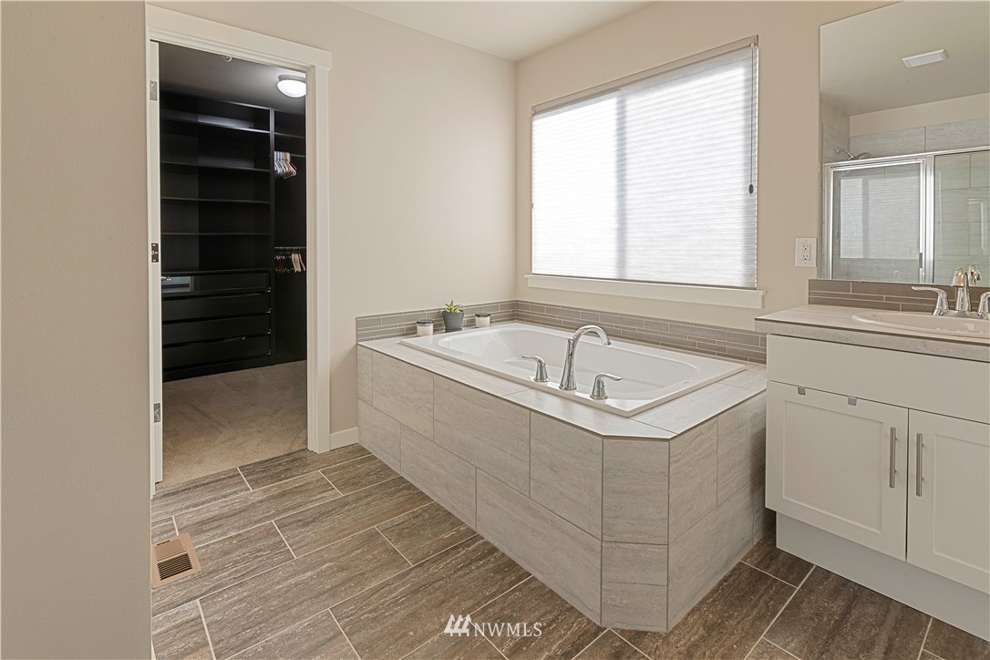 17512 Meridian Place West Bothell, WA 98012 - Photo 18 of 28 a bathroom with a sink a bathtub and window