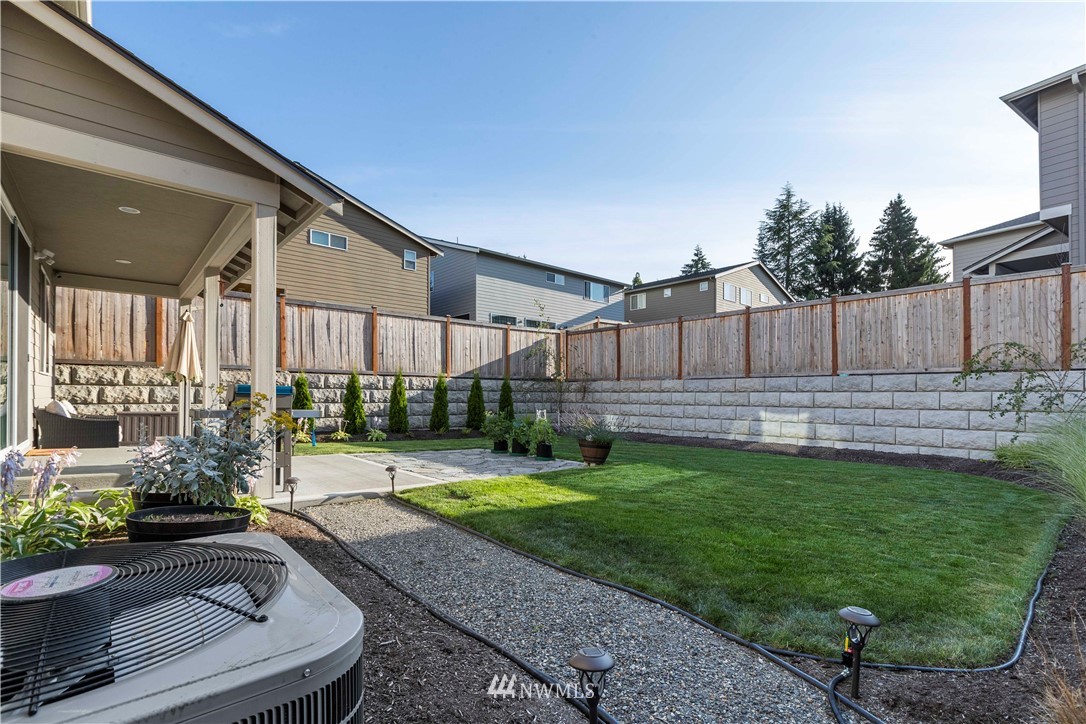 17512 Meridian Place West Bothell, WA 98012 - Photo 27 of 28 a view of a backyard with potted plants and wooden fence