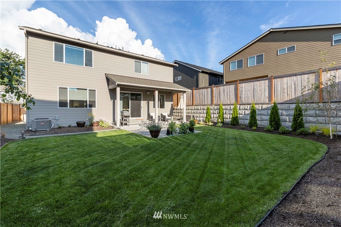 17512 Meridian Place West Bothell, WA 98012 - Photo 28 of 28 a front view of a house with a yard porch and outdoor seating