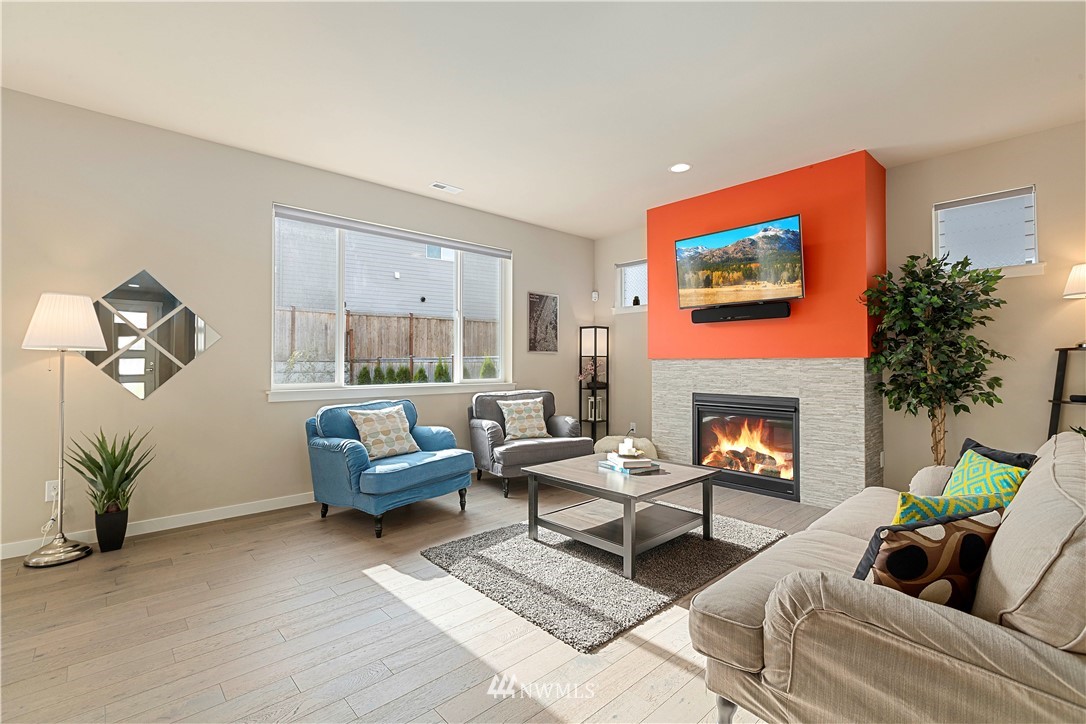 17512 Meridian Place West Bothell, WA 98012 - Photo 4 of 28 a living room with furniture a large window and a fireplace