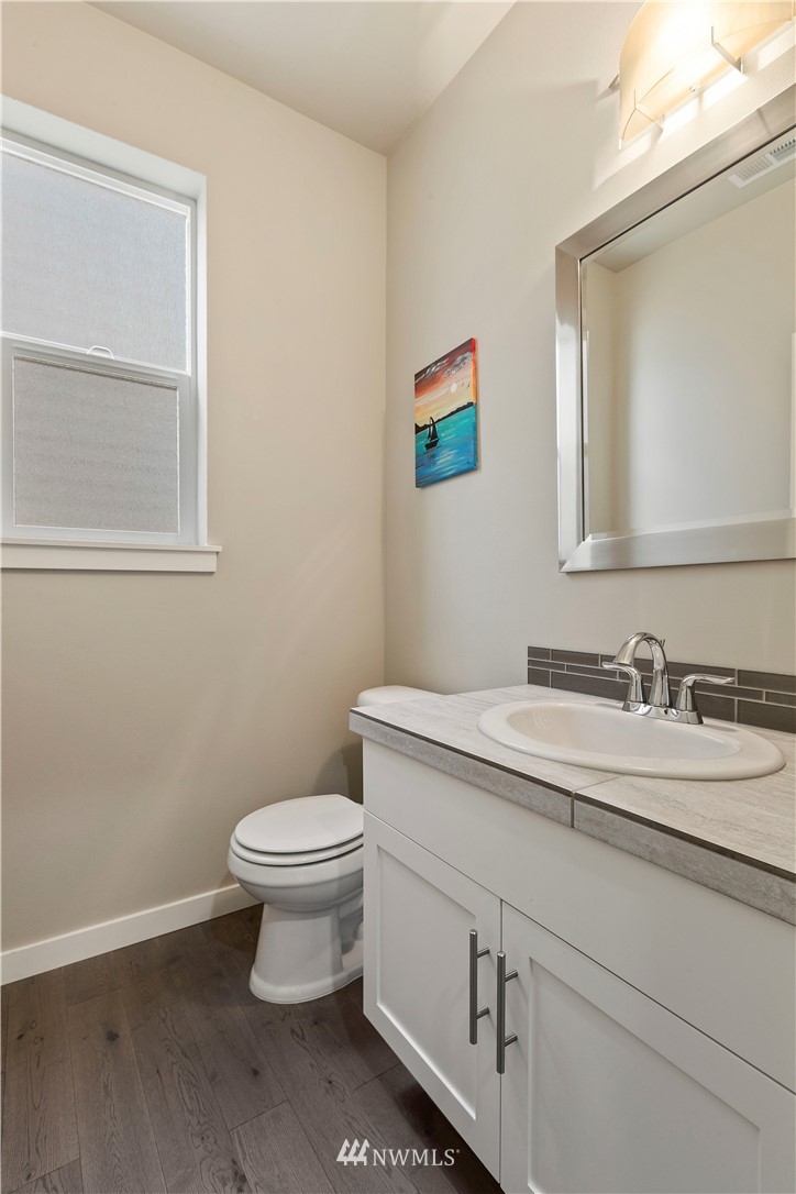 17512 Meridian Place West Bothell, WA 98012 - Photo 10 of 28 a bathroom with a granite countertop toilet and a sink