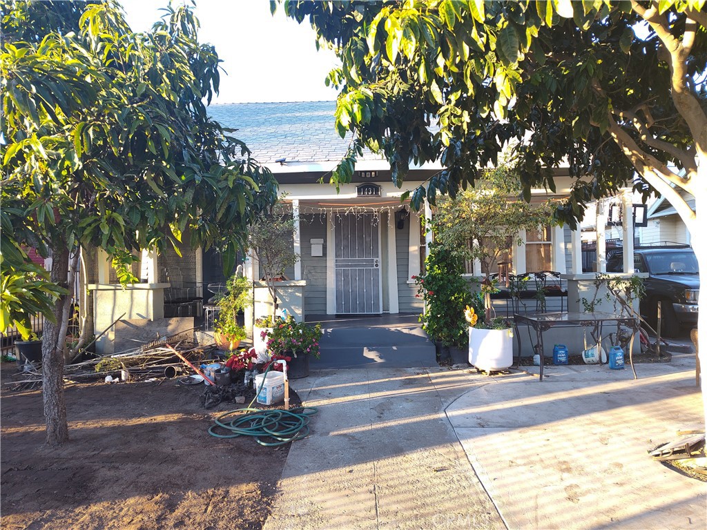 a view of a house with backyard sitting area and garden