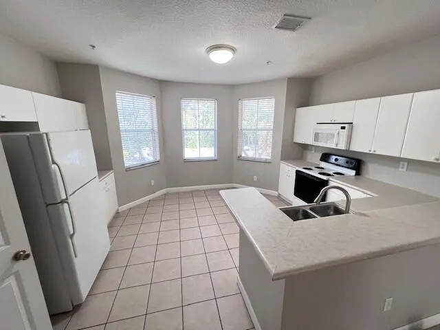 a kitchen with a sink a stove and refrigerator
