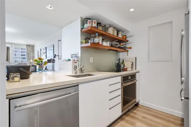 a kitchen with stainless steel appliances granite countertop a sink and cabinets
