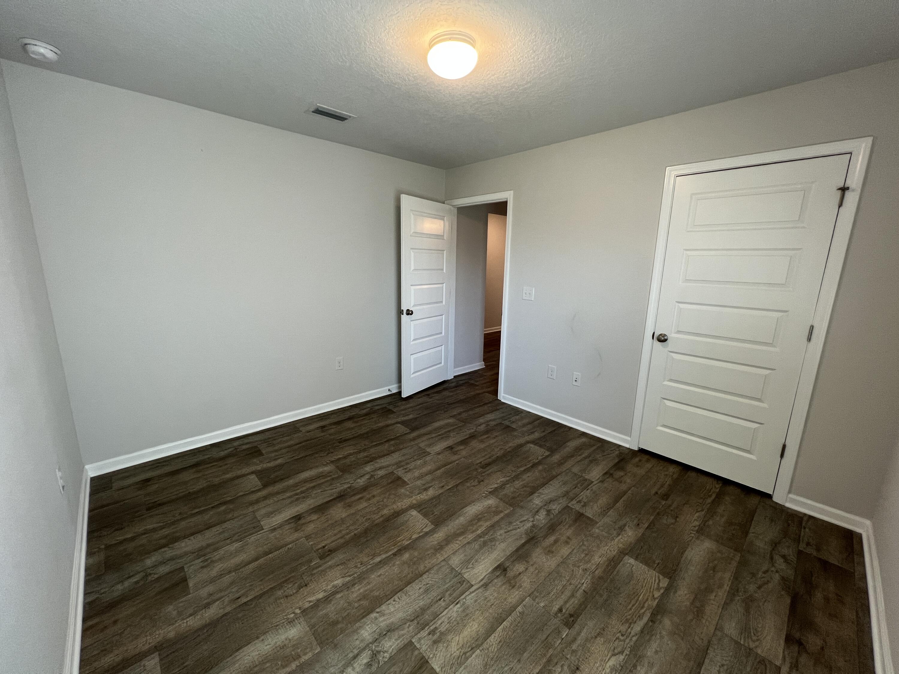 399 This Way Freeport, FL 32439 - Photo 11 of 29 wooden floor in an empty room