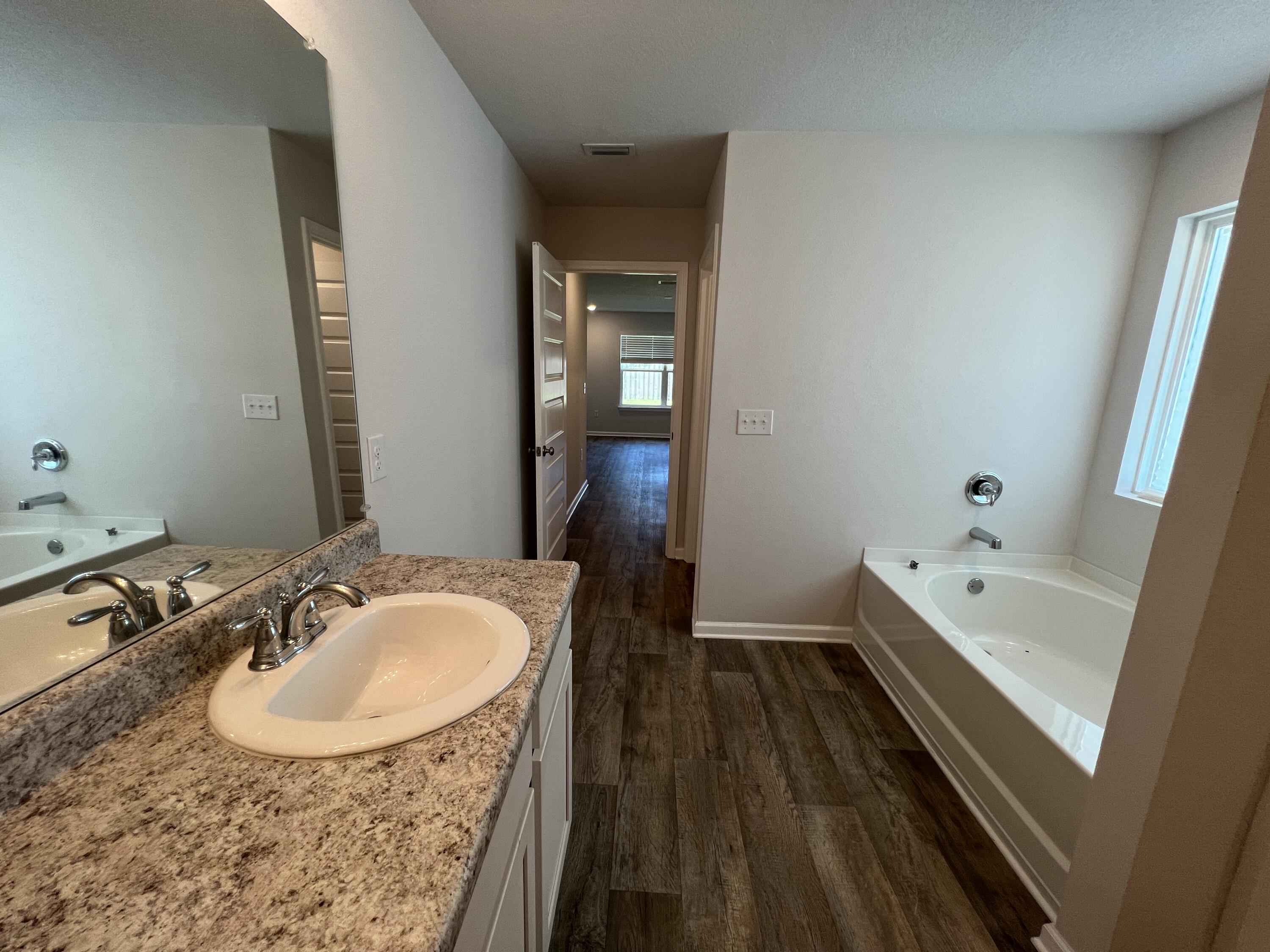 399 This Way Freeport, FL 32439 - Photo 16 of 29 a bathroom with a tub sink and mirror