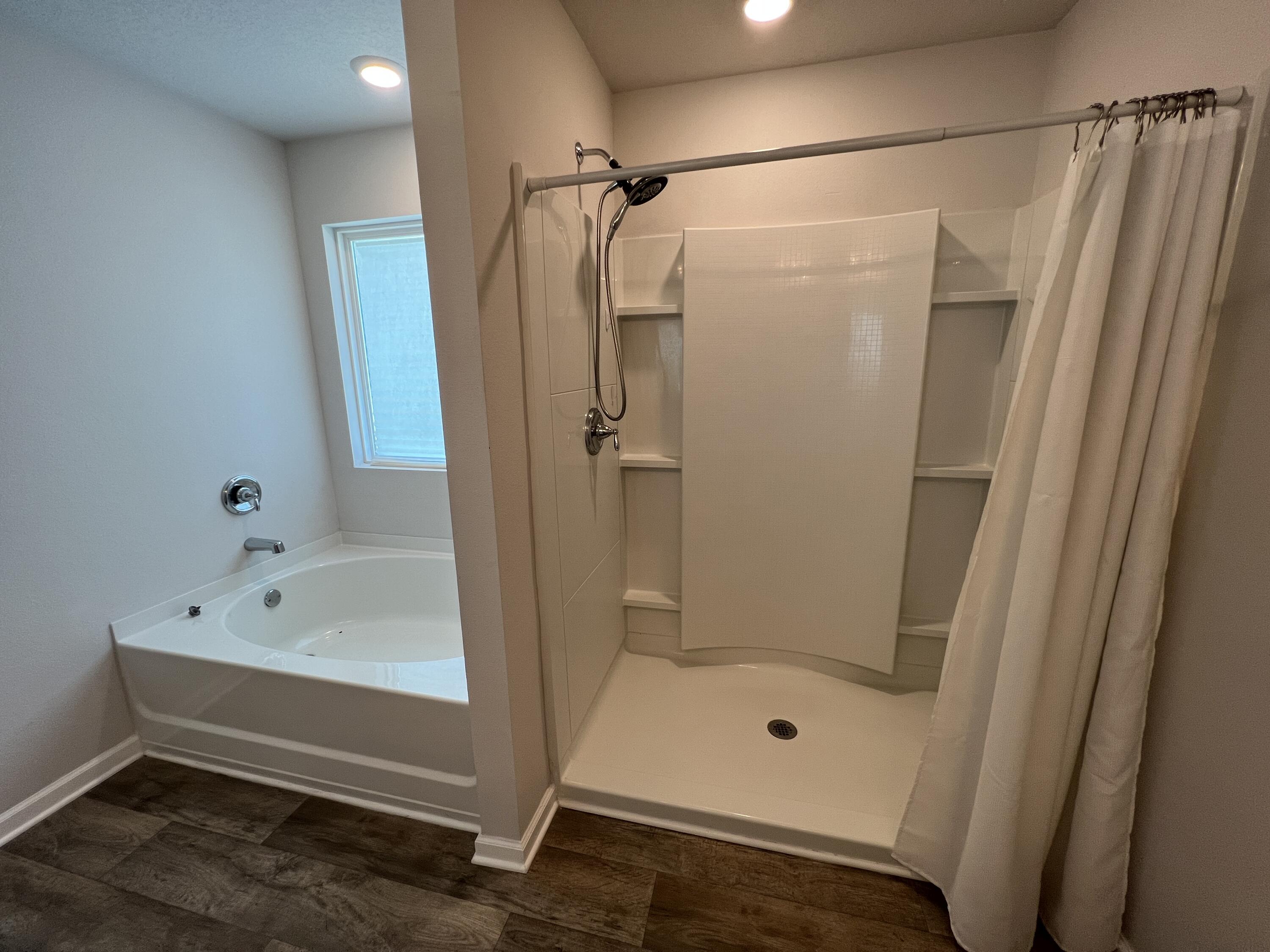 399 This Way Freeport, FL 32439 - Photo 17 of 29 a bathroom with a tub and a shower