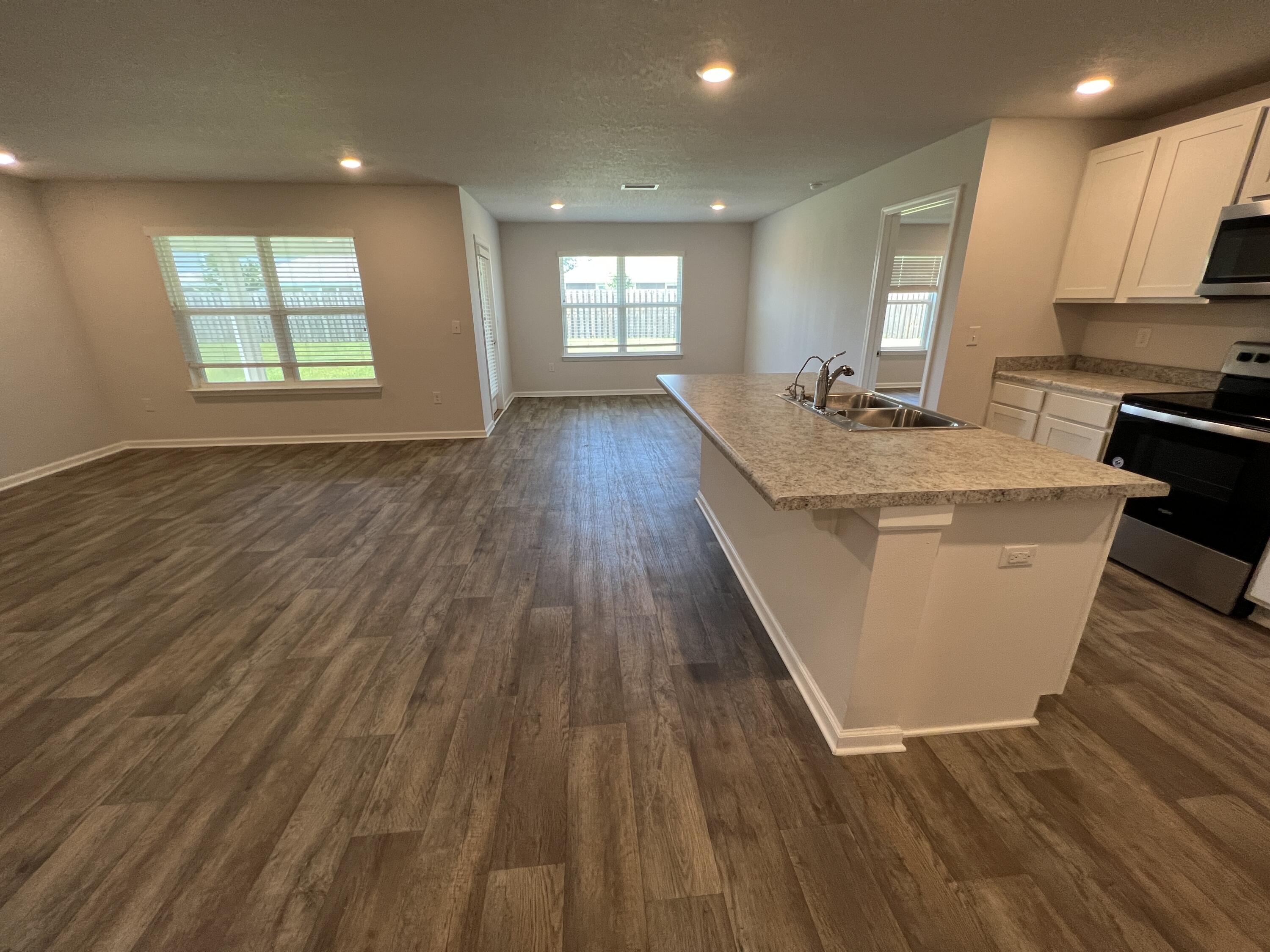 399 This Way Freeport, FL 32439 - Photo 3 of 29 a large kitchen with stainless steel appliances a large window a sink and a oven