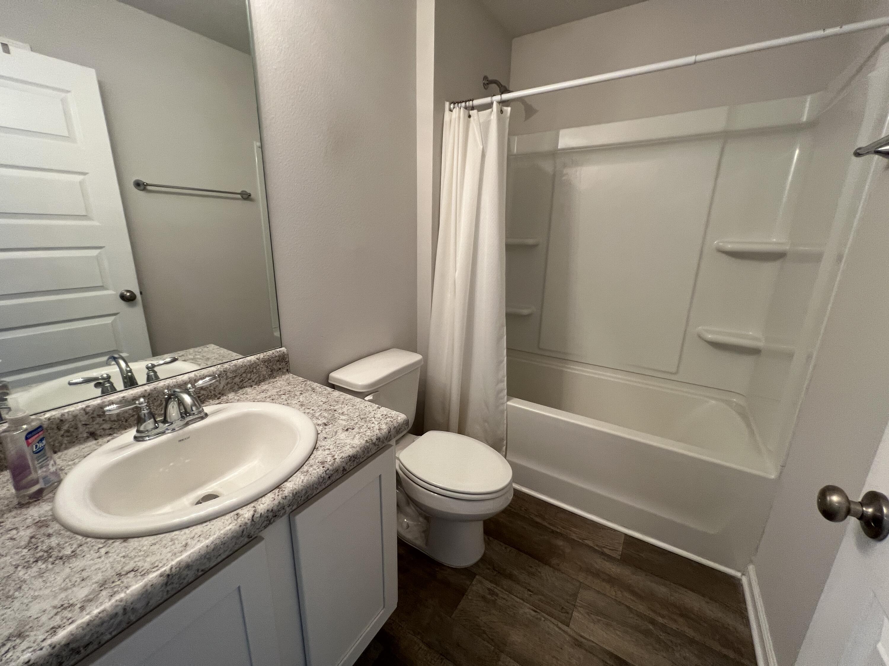 399 This Way Freeport, FL 32439 - Photo 9 of 29 a bathroom with a granite countertop sink toilet and shower