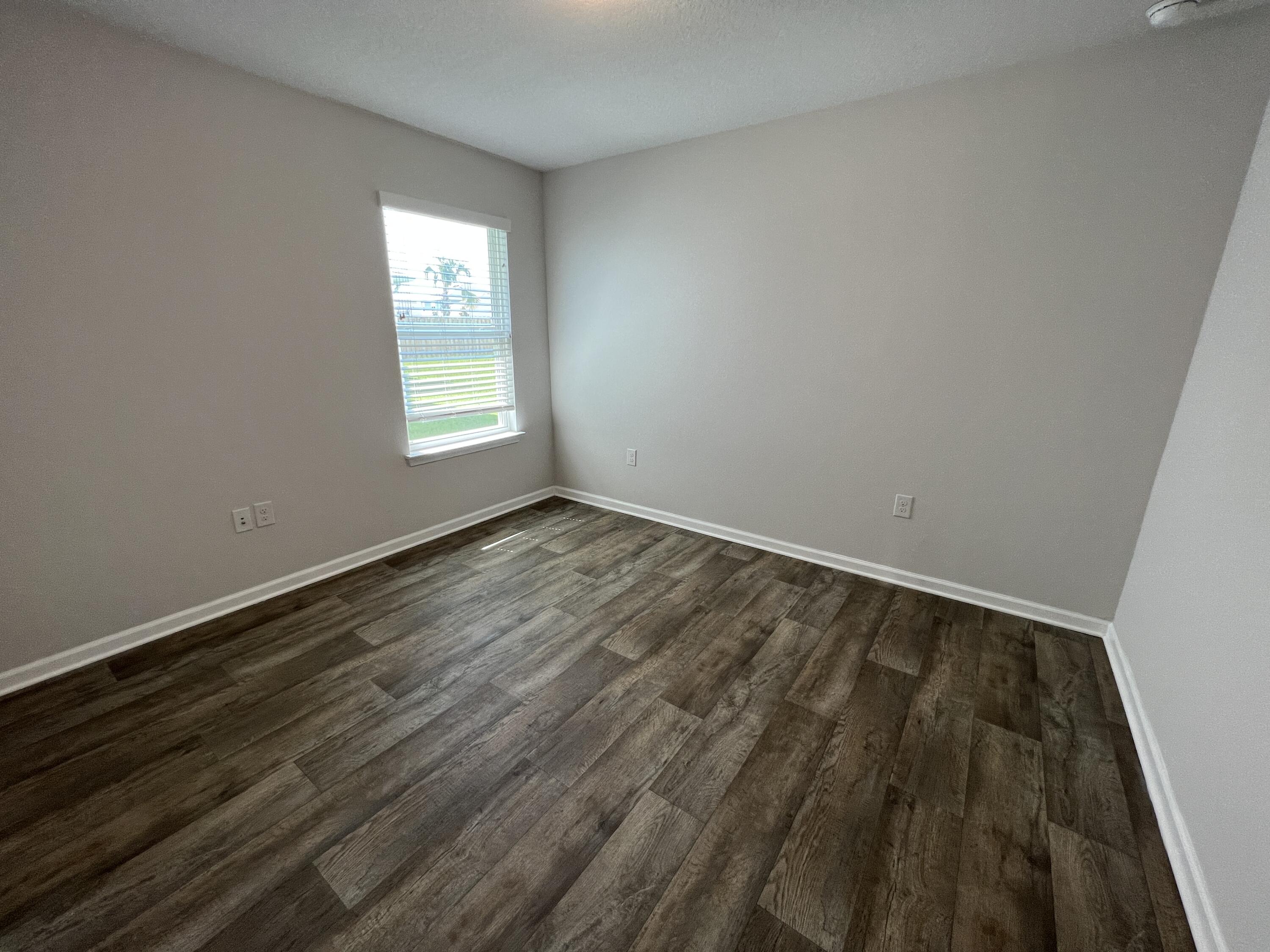399 This Way Freeport, FL 32439 - Photo 10 of 29 a view of room with window and hardwood floor