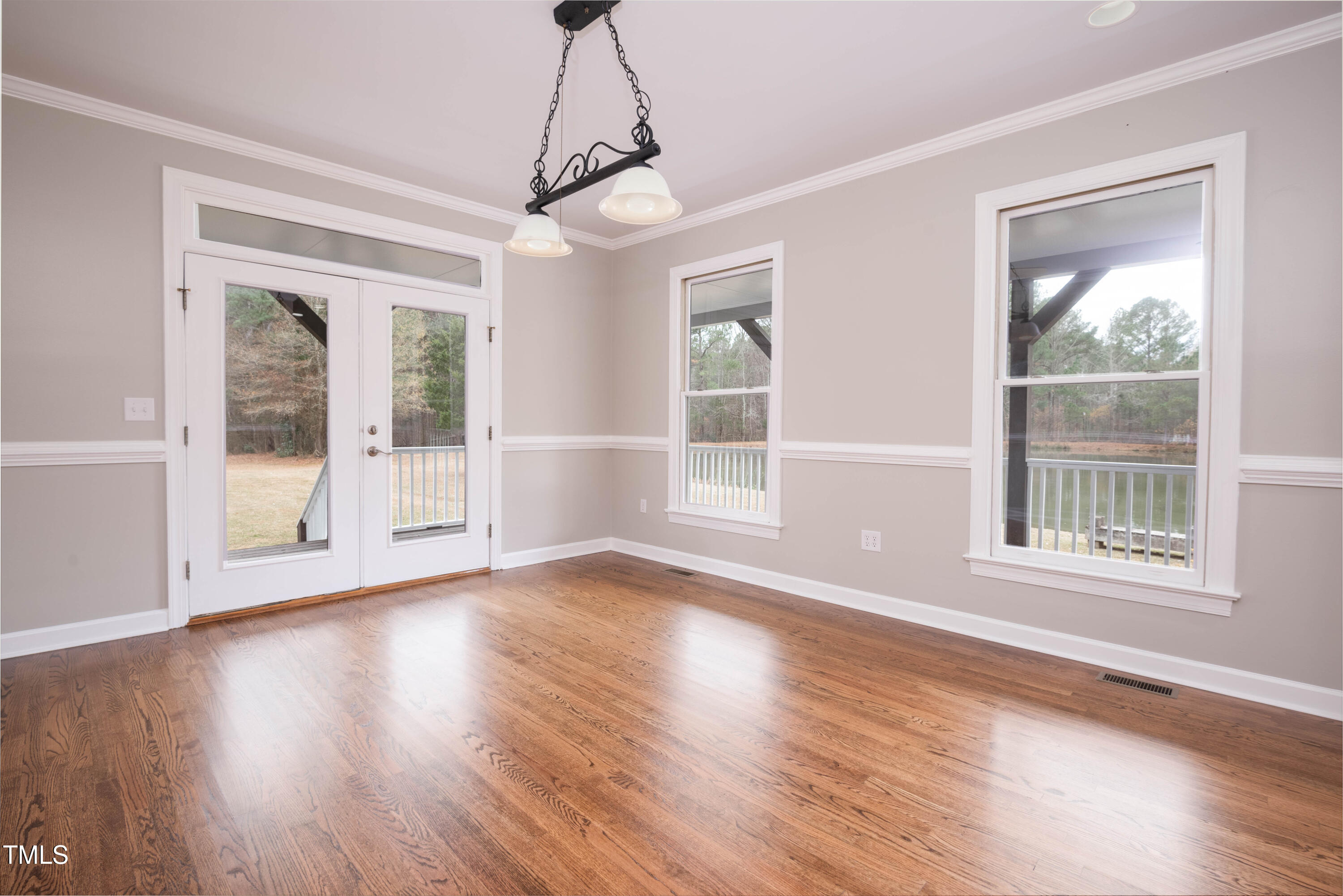 4222 Rogers Road Durham, NC 27703 - Photo 11 of 84 a view of an empty room with wooden floor and a window