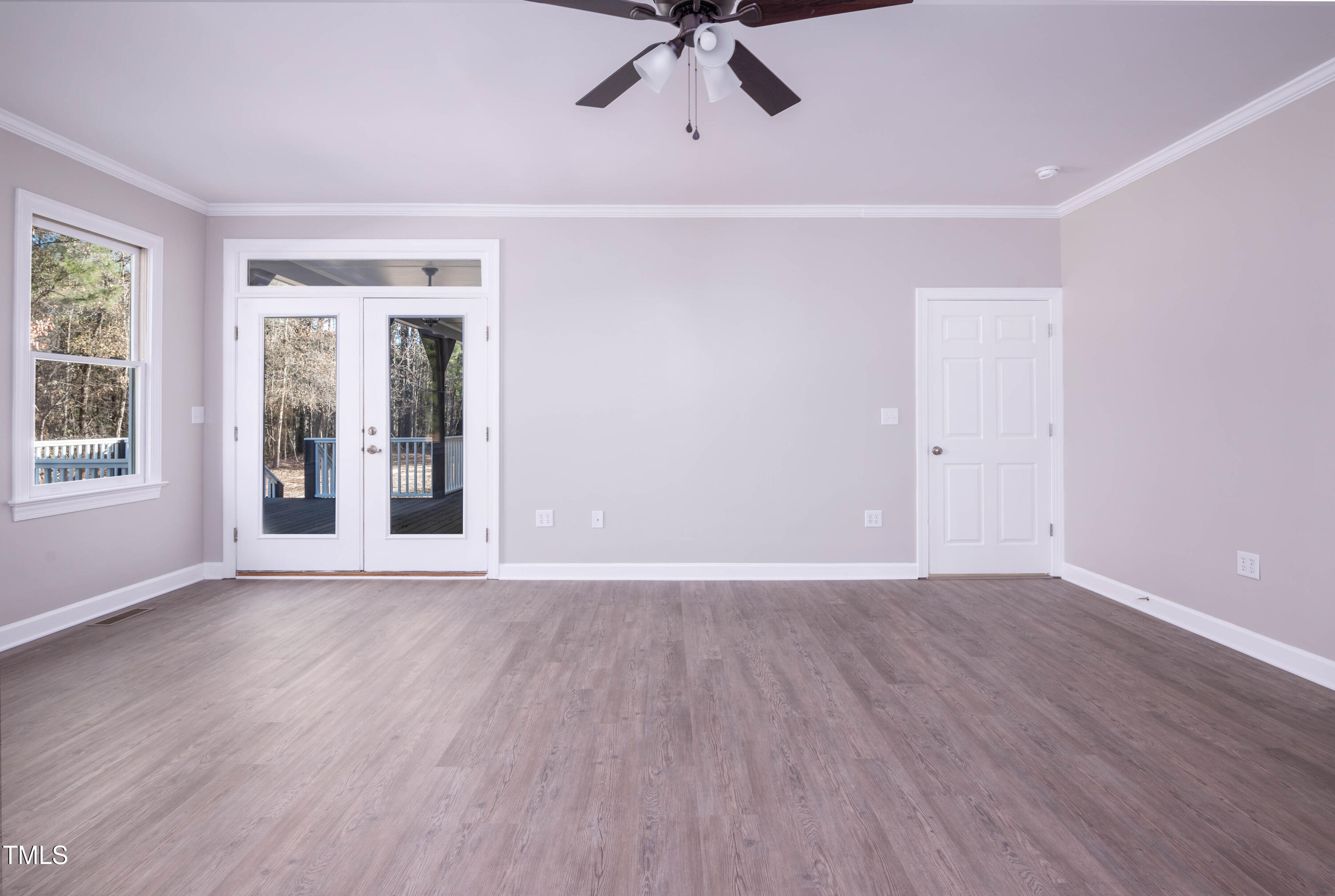 4222 Rogers Road Durham, NC 27703 - Photo 29 of 84 a view of an empty room with wooden floor and a window