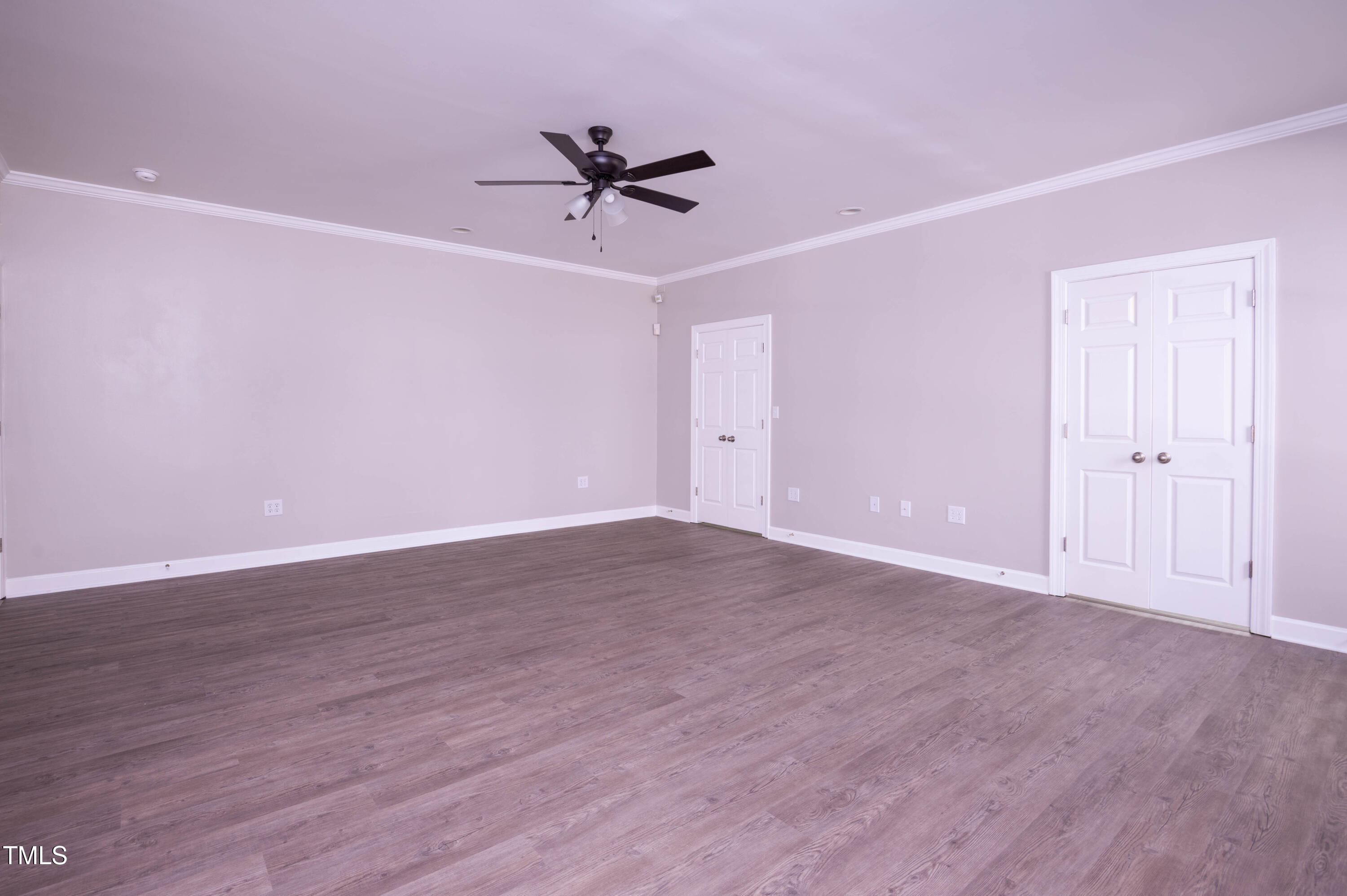 4222 Rogers Road Durham, NC 27703 - Photo 35 of 84 a view of an empty room with wooden floor and a ceiling fan