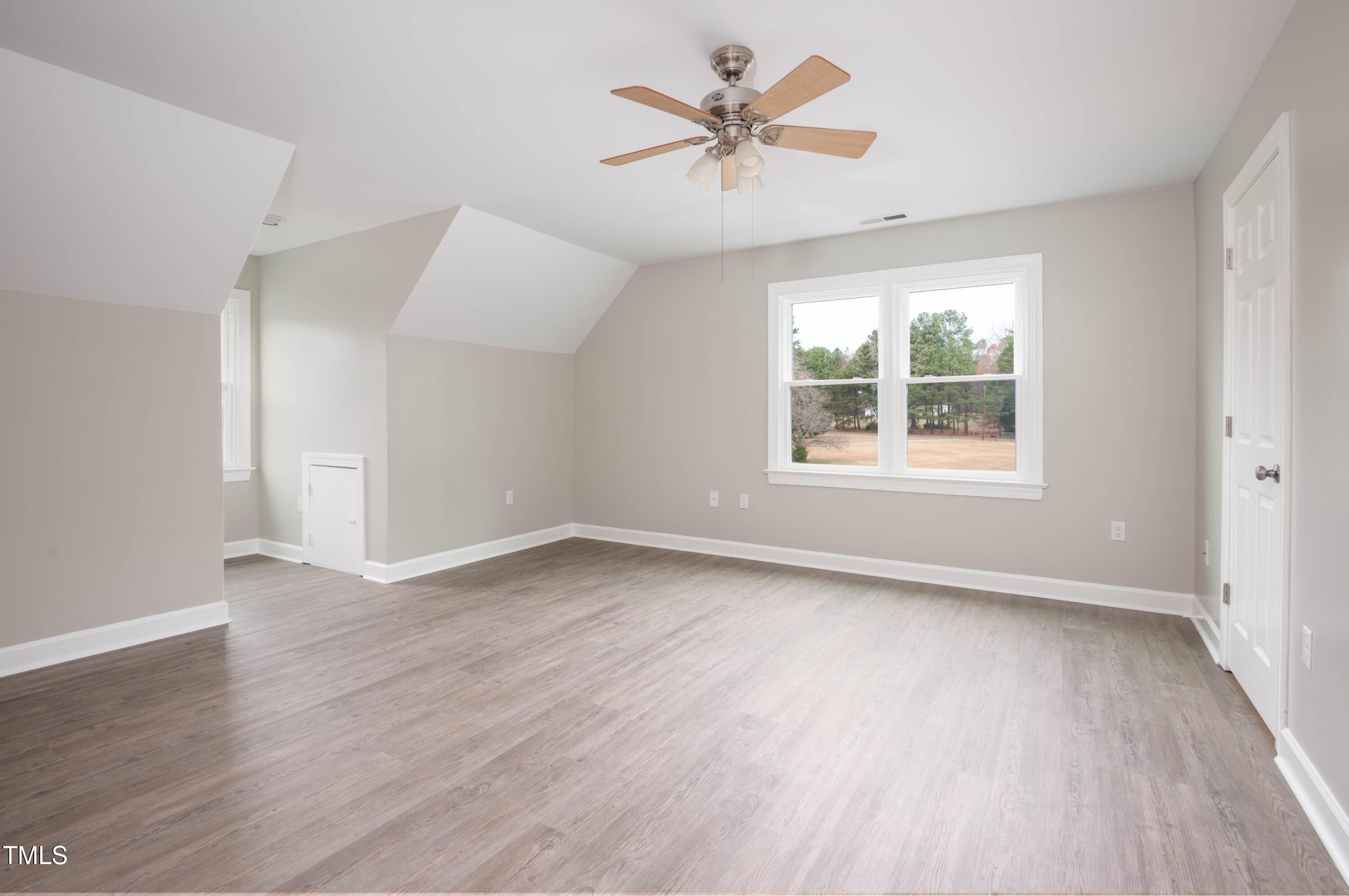 4222 Rogers Road Durham, NC 27703 - Photo 54 of 84 an empty room with wooden floor and windows