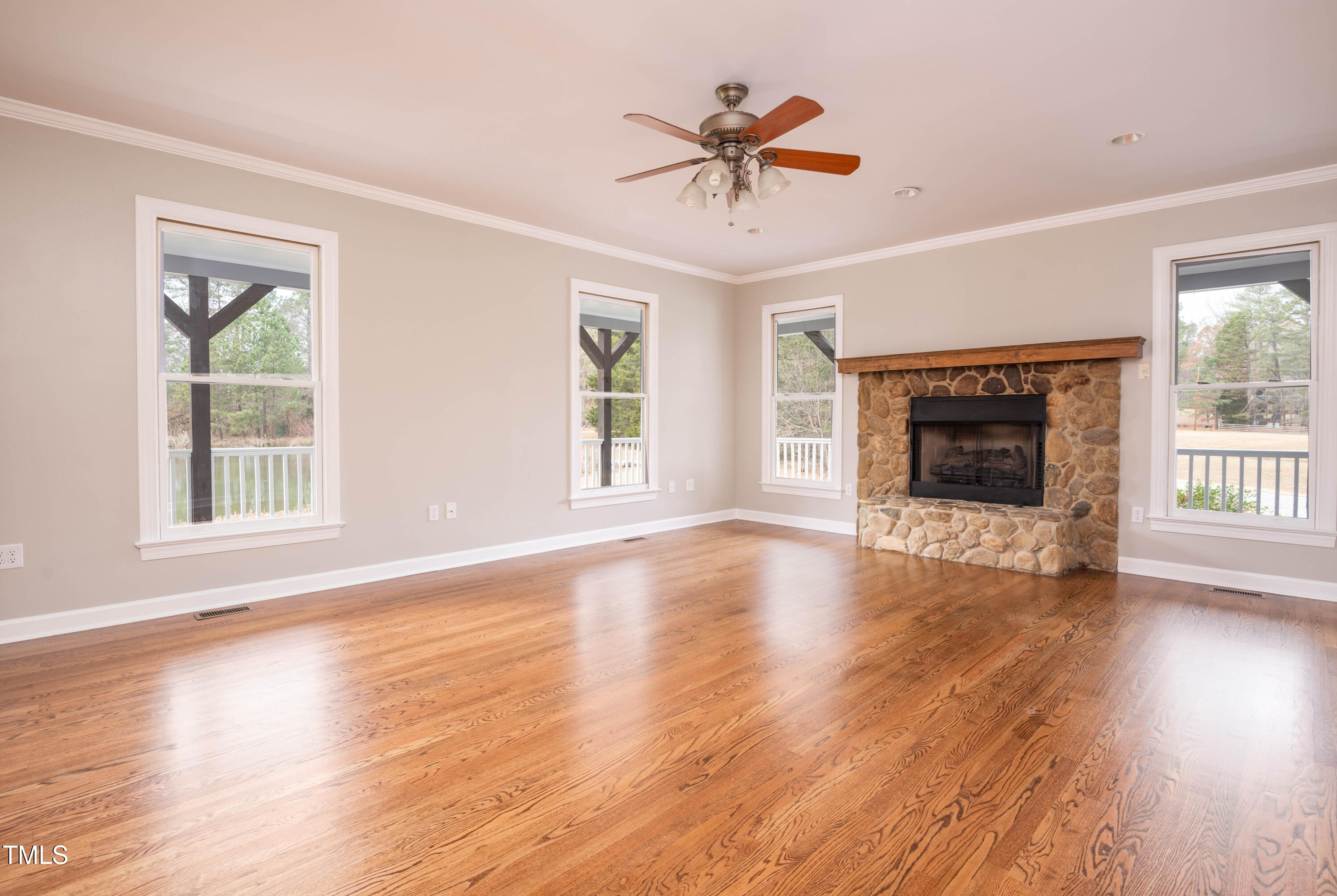4222 Rogers Road Durham, NC 27703 - Photo 7 of 84 a view of an empty room with wooden floor and a window