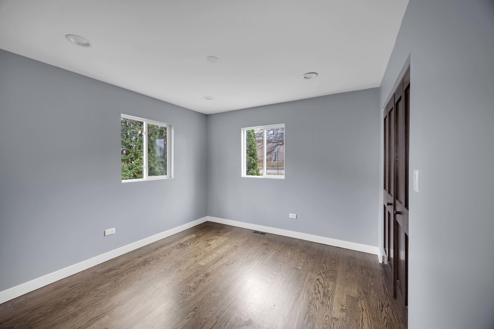 9059 Oneill Drive Burr Ridge, IL 60527 - Photo 11 of 15 an empty room with wooden floor and windows