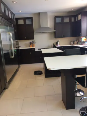 a kitchen with a sink and a refrigerator