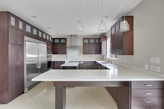a kitchen with cabinets and stainless steel appliances