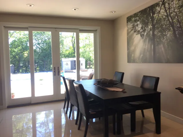 a view of a dining room with furniture and window